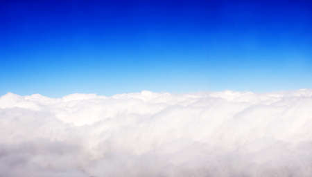Aerial view from the aircraft to beautiful white clouds in the blue sky