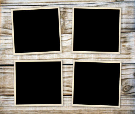 Four retro photos on old wooden boards. Vintage blank photo frames on wooden table top. Mock up template. Copy space for your textの写真素材