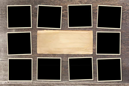 Ten retro photos on old wooden board. Vintage blank photo frames and empty paper sheet on wooden table top. Mock up template. Copy space for your textの写真素材