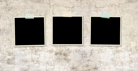 Three retro photos on old stucco wall. Vintage blank photo frames. Mock up template. Copy space for...