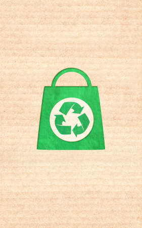 Responsible consumption. Arrows recycle symbol and shopping bag in paper cut style. Eco-friendly business. Vertical banner with recycled eco paper texture. Copy space for text. Mock up templateの写真素材