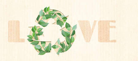 Arrows recycle symbol and green leaves on cardboard texture. Inscription Love. Banner with eco paper texture. Paper cardboard background. Recycled carton material. Ecology concept. Copy space for textの写真素材