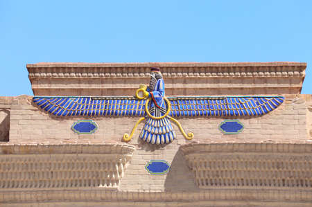 Sign of Zoroastrianism Faravahar (Frahvahar). Zoroastrian symbol on the temple wall, Yazd, Iranの写真素材