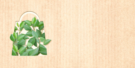 Responsible consumption. Green leaves and shopping bag in paper cut style. Eco-friendly business. Horizontal banner with recycled eco paper texture. Copy space for textの写真素材