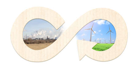 Ecology, nature, pollution and clean energy concept. Environmental pollution. Circular economy symbol and factory plant smoke, smog, polluted grass and and green grass and wind turbines under blue skyの写真素材