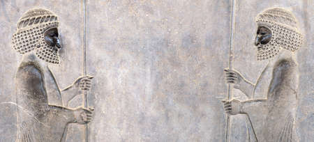 Ancient wall with bas-relief - two assyrian warriors with spears, Persepolis, Iran.の写真素材