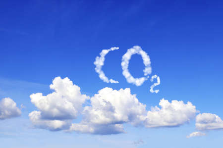 Symbol CO2 from clouds on blue sky. Carbon dioxide emission control. Pollution, global warming and climate change conceptの写真素材