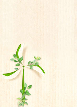 Ecology, nature and clean alternative energy concept. Wind turbine on cardboard texture. Vertical banner with eco paper texture and green leaves. Recycled carton background. Copy space for textの写真素材
