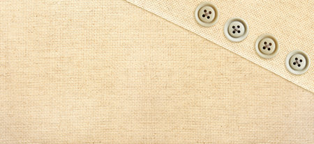 Horizontal or vertical background with beige canvas texture and buttons. Natural linen texture backdrop. Copy space for textの写真素材
