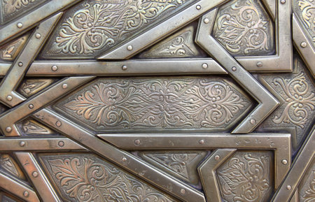 Detail of metal door with traditional islamic ornament. Copper window shutter with antique and national moroccan floral pattern. Oriental ornaments with artistic with chasing for brassの写真素材