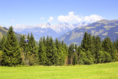 Alps mountains in Tirol, Austria. View of idyllic mountain scenery in Alps with cableway over a forest. European mountain landscape with cable car in National park High Tauern (Hohe Tauern)の写真素材