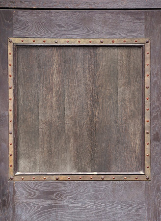 Texture of vintage wood boards with medieval metal decorative border. Vertical retro background with old wooden planks and metalic frame. Mock up template. Copy space for textの写真素材