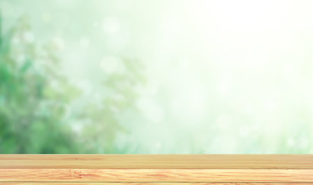 Old wooden table and abstract green background. Empty wooden table top on blurred backdrop. Rustic wooden board on nature background. Product display template. Copy space for textの写真素材