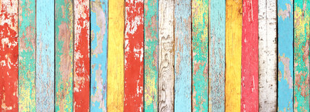 Texture of vintage wood boards with cracked paint of white, red, yellow, cyan and blue color. Horizontal retro background with old wooden planks of different colorsの写真素材