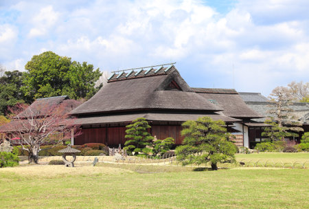 Beautiful spring scenic with ancient pavilion and stone lantern in Koishikawa Korakuen garden, Okayama, Japanのeditorial素材