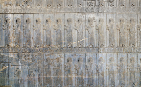 Ancient wall with bas-relief with assyrian warriors with spears, Persepolis, Iran. UNESCO world heritage siteのeditorial素材