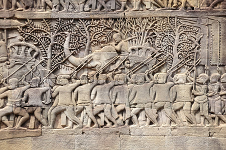 Wall carving with depicting troops, soldiers and military leaders on elephants in Prasat Bayon Temple, in famous Angkor Wat complex, khmer culture, Siem Reap, Cambodia.の写真素材