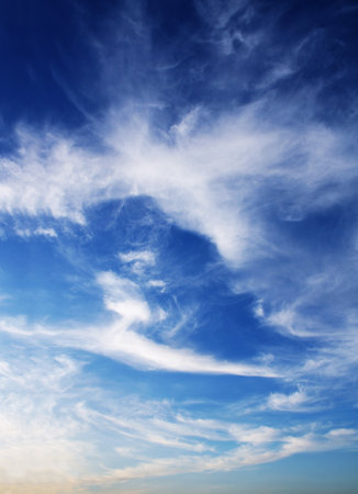 White clouds in the blue sky. Beautiful nature scene with sunset cloudscape. Vertical background with sunrise sky scenicの写真素材