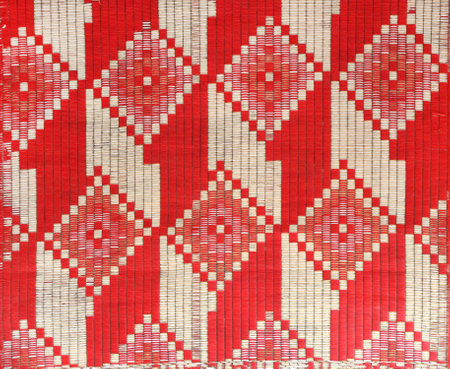 Sisal mat with traditional asian geometric patterns. Jute handmade rug with ornament of red and yellow colorの写真素材