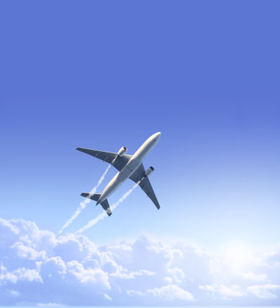 Vertical nature background with aircraft and Jet trailing smoke in the sky. Airplane and condensation trail. Foggy trail jet and plane in blue sky with white clouds. Traveling the world conceptの写真素材
