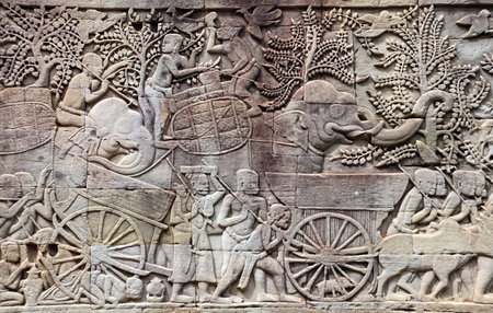 Wall carving of Prasat Bayon Temple in famous landmark Angkor Wat complex, Siem Reap, Cambodia. Bas-relief depicting women, child, bulls, elephants. UNESCO world heritage siteのeditorial素材
