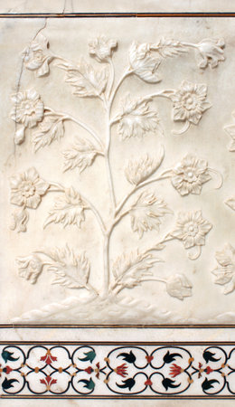 Ancient carved bas-relief with flowers on marble. Beautiful ornament with carved flower on the wall of the famous mausoleum Taj Mahal, India. UNESCO world heritage siteのeditorial素材