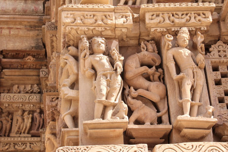 Decorative wall carving ornament with figurine of mythical character, demon, elephant, griffin. Western Temples in Khajuraho (Temples of love), Madya Pradesh, India.の写真素材