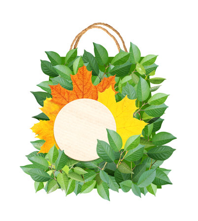 Responsible consumption. Shopping bag made from green and yellow maple leaf. Changing Seasons. Eco-friendly business. Ecology and zero waste concept. Isolated on white background. Copy space for textの写真素材