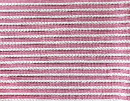Light pink and white style striped fabric texture. Background with  striped closeup weave fabric. Pinstripe material of pink and white colorsの写真素材