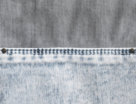 Grey and light grey  denim background with a seam. Light gray color denim jeans fabric texture. Copy space for textの写真素材