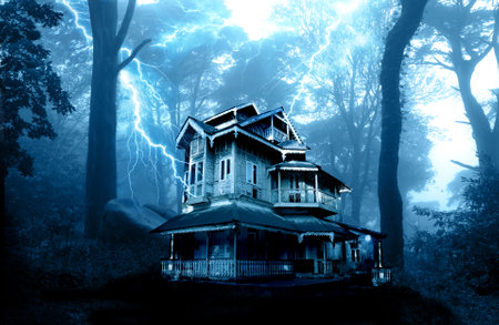 Horizontal Halloween banner with haunted house and lightnings in scary forest. Thunderstorm with lightning and abandoned house. Scary cottage in mysterious forestland. Photo toned in blue colorの写真素材