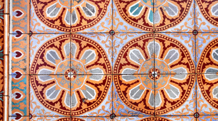 Ancient tiles floor texture with floral ornament of orange, blue and white colorsの写真素材