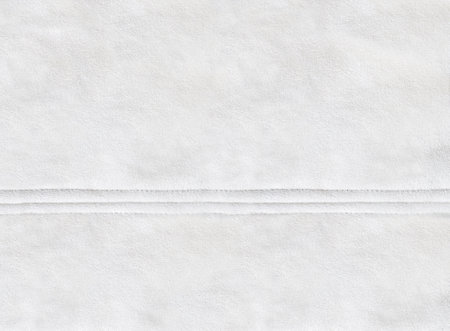 Horizontal or vertical backdrop with suede texture of ivory color. Background for scrapbooking design, decoration with suede leather and seam. Copy space for textの写真素材