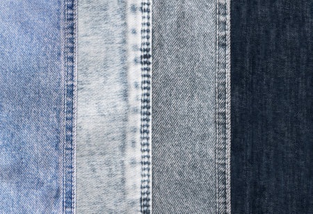 Horizontal or vertical background with denim patches of light grey, blue and black colors cotton texture. Decorative striped backdrop with blue, indigo, black and gray color denim jeans fabricの写真素材