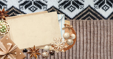 Eco friendly Christmas. Christmas background with retro card, gift, star anise and wooden snowflakes on wool sweater. Copy space for text. Ecology, environmental conservation and zero waste conceptの写真素材