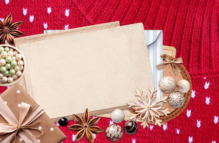 Eco friendly Christmas. Christmas background with retro card, gift, star anise and wooden snowflakes on wool sweater. Copy space for text. Ecology, environmental conservation and zero waste conceptの写真素材