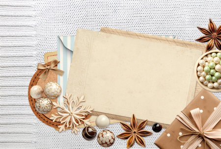 Eco friendly Christmas. Christmas background with retro card, gift, star anise and wooden snowflakes on wool sweater. Copy space for text. Ecology, environmental conservation and zero waste conceptの写真素材