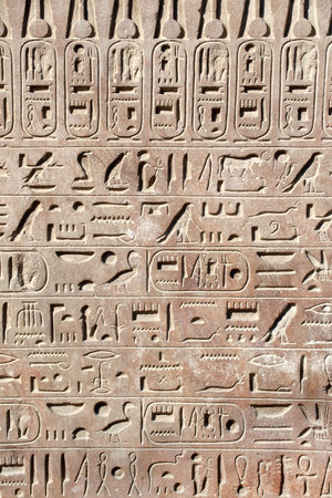Ancient Egyptian hieroglyphs on stone wall, Karnak Temple Complex, Luxor, Egypt, Africa. Stone carvings with hieroglyphs at Karnak temple, Luxor, Thebesの写真素材