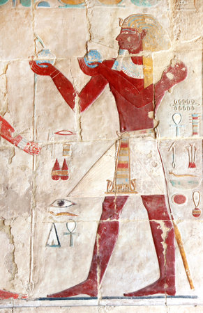 Ancient Colorful Mural Wall Painting inside Hatshepsut Temple in Valley of the Kings, Luxor, Egypt. Figure of the pharaoh making ritual offerings, wall of the Hatshepsut temple in Western Thebesの写真素材