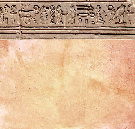 Vertical background with ancient Egyptian hieroglyphs on stone wall, Egypt, Africa. Backdrop with sandstone carving with hieroglyph. Mock up template. Copy space for textの写真素材