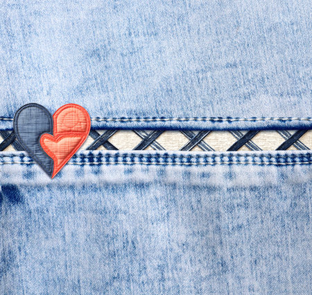 Light blue denim background with a seam and felt heart. Suqare blue color denim jeans fabric texture with heart-shaped textile patch. Valentine's day denim backdrop. Copy space for textの写真素材