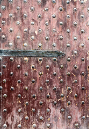 Detail of old wooden gate leaf part. Ancient wood door with metal rivets in Qaitbay Citadel, Alexandria, Egyptの写真素材