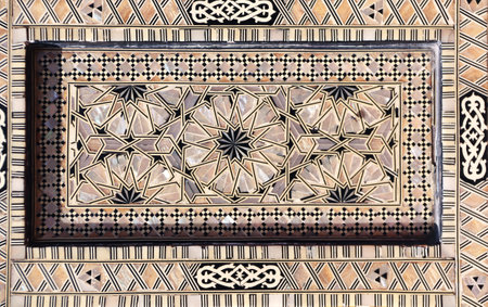 Detail of ancient mosaic window shutter with mother-of-pearl ornaments. Horizontal or vertical background with traditional moroccan tile decorationの写真素材