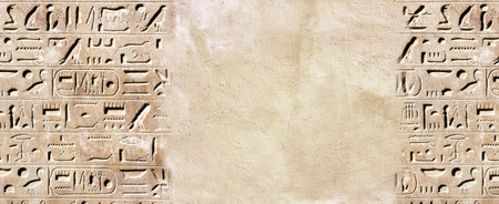 Horizontal background with ancient Egyptian hieroglyphs on stone wall, Egypt, Africa. Backdrop with sandstone carving with hieroglyph. Mock up template. Copy space for textの写真素材