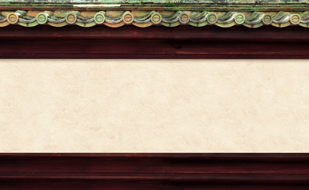 Stucco wall of traditional japanese house with oriental decorative roof tile. Oriental horizontal background. Mock up template. Copy space for textの写真素材