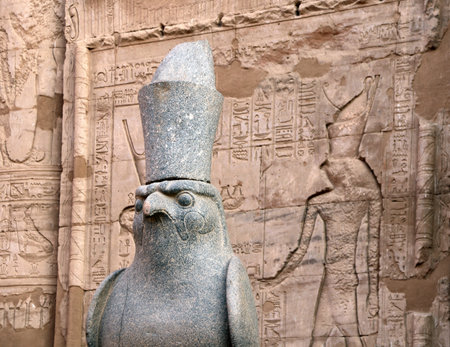 Granite statue of God Horus falcon at entrance Temple of Horus, Edfu, Egypt. Famous landmark ptolemaic Horus Temple in Idfu (Edfou, Behdet), Egyptの写真素材
