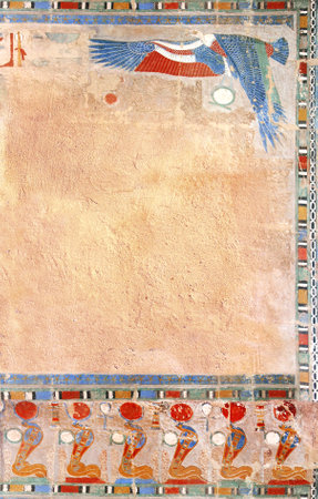 Vertical background with Ancient Egyptian Colorful Mural Wall Painting and stucco wall texture. Frame in egyptian style with Figure of eagle and cobras. Mock up template. Copy space for textの写真素材