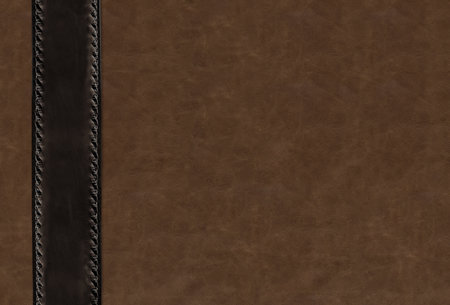 Horizontal or vertical leather background of brown colors with decorative belt of black color with braided edging . Decorative backdrop with cowhide texture and braided edge. Copy space for textの写真素材