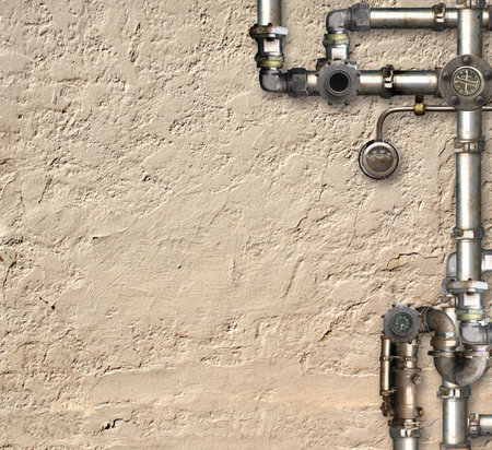 Vintage steampunk backdrop with pipes on stucco wall. Open space with concrete wall and retro...