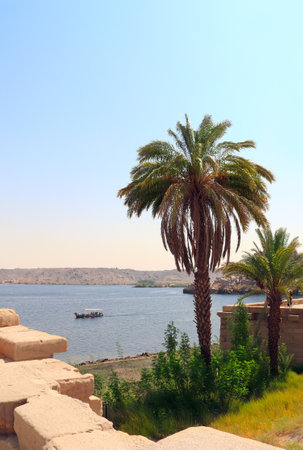 Tourist boat tour on the Nile River, Egypt. Beautiful landscape of reservoir of Aswan Low Dam, near to Temple of Isis on Agilkia Island (Philae). Summer vacation, relaxing on cruise shipsの写真素材